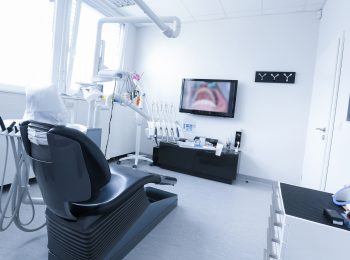 Dentists office with live picture of teeth in the background. Dental care, dental hygiene, checkup and therapy concept.